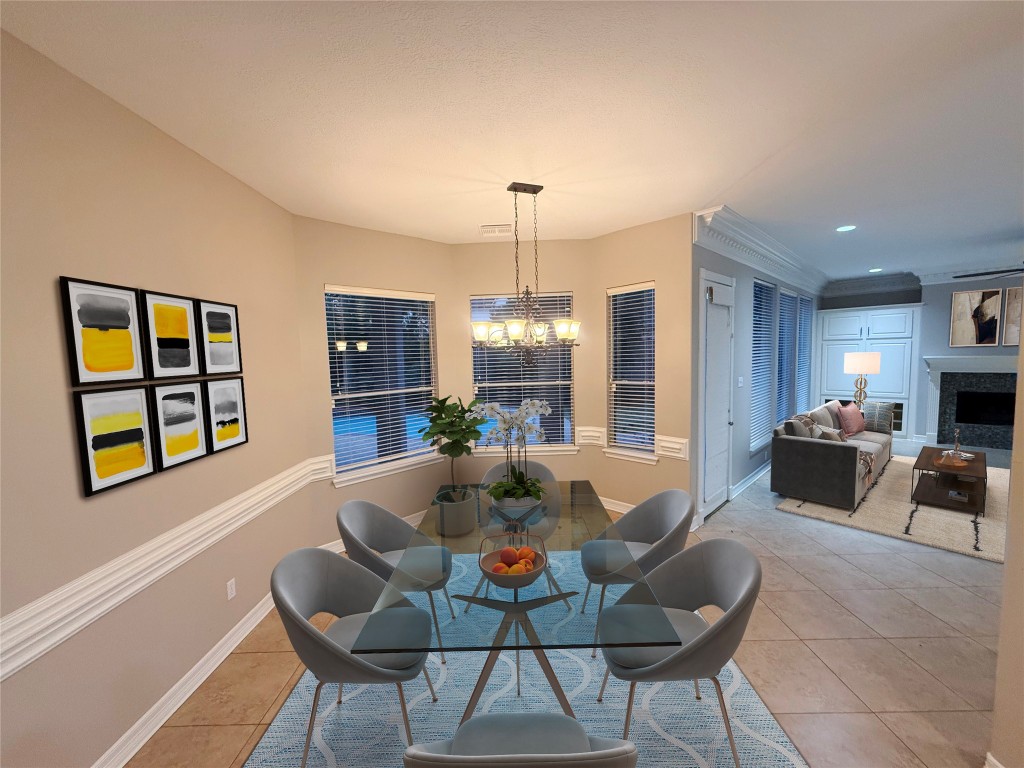 13523 Pegasus Road Cypress, TX 77429 - Photo 3 of 36 a living room with furniture a fireplace and a chandelier