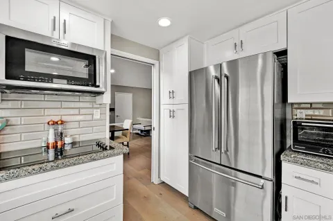 a kitchen with stainless steel appliances a refrigerator stove and microwave