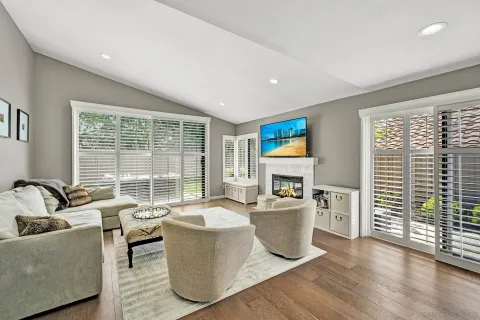 a living room with furniture and large windows
