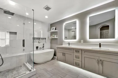 a spacious bathroom with a double vanity sink a mirror and a bathtub