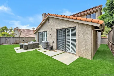 a view of backyard with a garden and deck