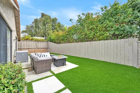 a view of backyard with outdoor seating and green space