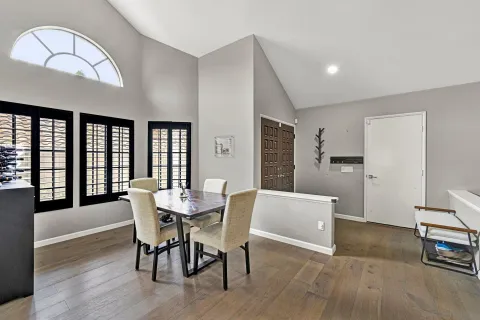 a view of a dining room with furniture and wooden floor