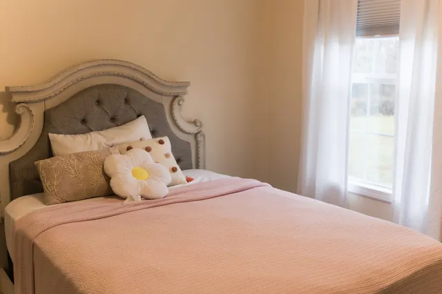 a bedroom with a bed and a window