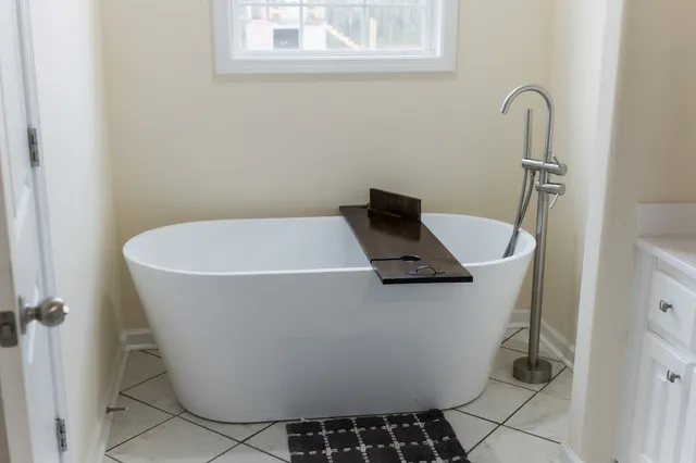 a white bath tub sitting in a bathroom