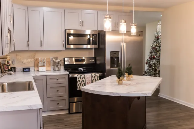 a kitchen with refrigerator and cabinets