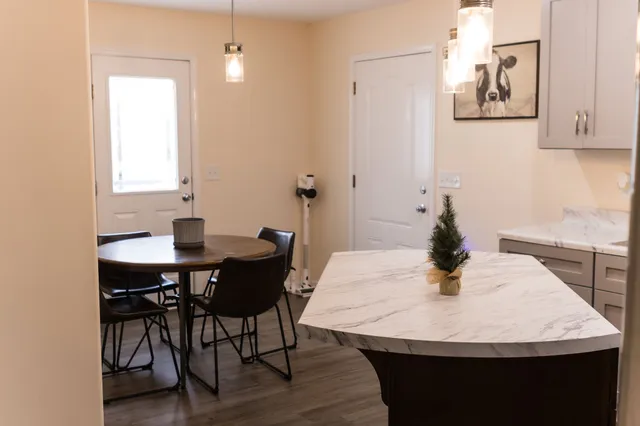 a kitchen with a table and chairs in it