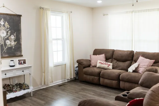 a living room with furniture and a fireplace