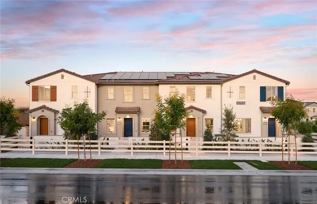 front view of house with a big yard and large trees