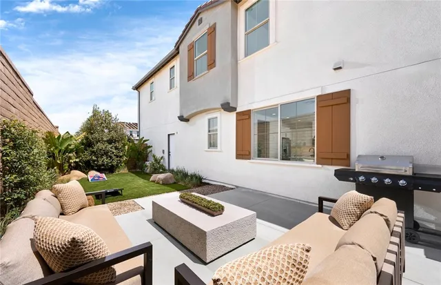 a view of a patio with couches table and chairs with potted plants