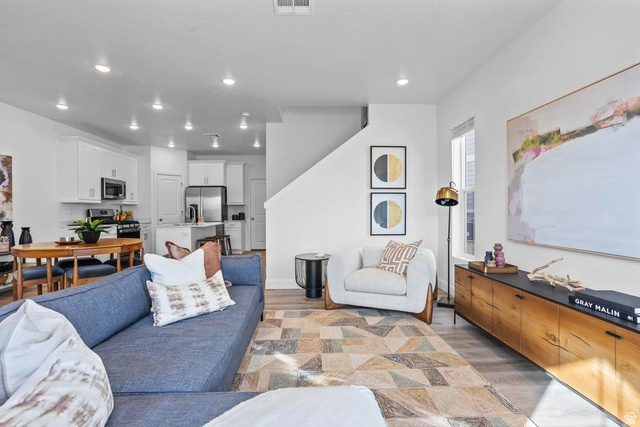 488 West Greenstone Pl Street, Unit 1010 St. George, UT 84790 - Photo 10 of 34 Open-concept living space featuring wood-finish flooring, recessed lighting, and a window for natural illumination