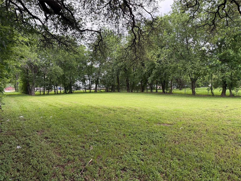 516 Indiana Avenue Waco, TX 76707 - Photo 4 of 6 a view of a green field with trees in the background