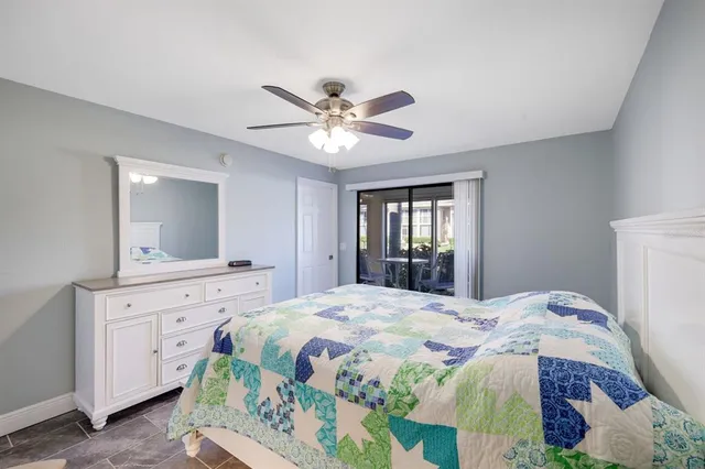 a bedroom with a bed and a chandelier fan