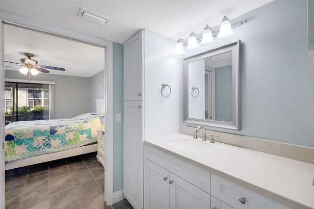 a en suite bathroom with a sink mirror and a bathtub