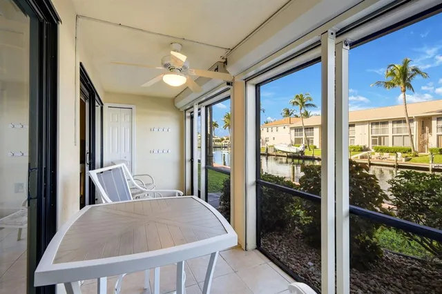 a view of a hallway with a dining table & chairs