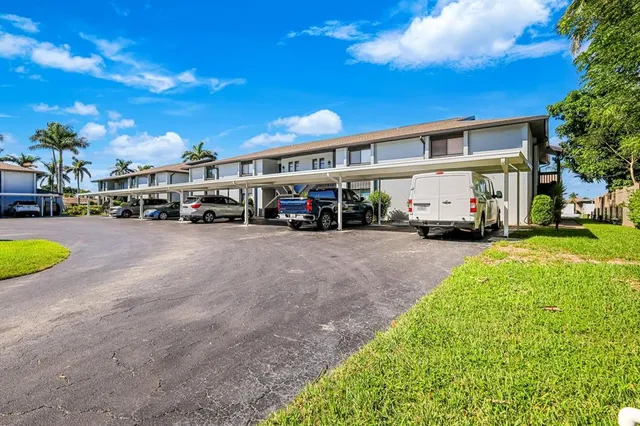 a view of a cars park in front of a house