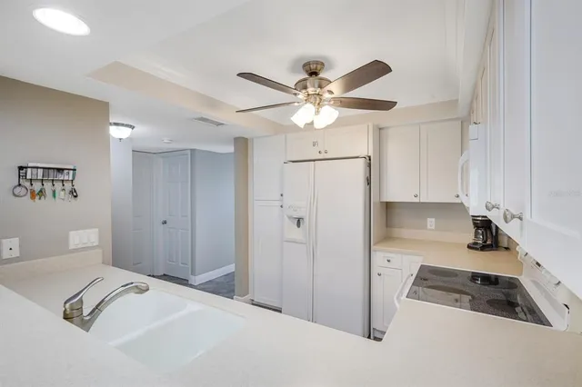 a view of a kitchen with a sink furniture and a ceiling fan