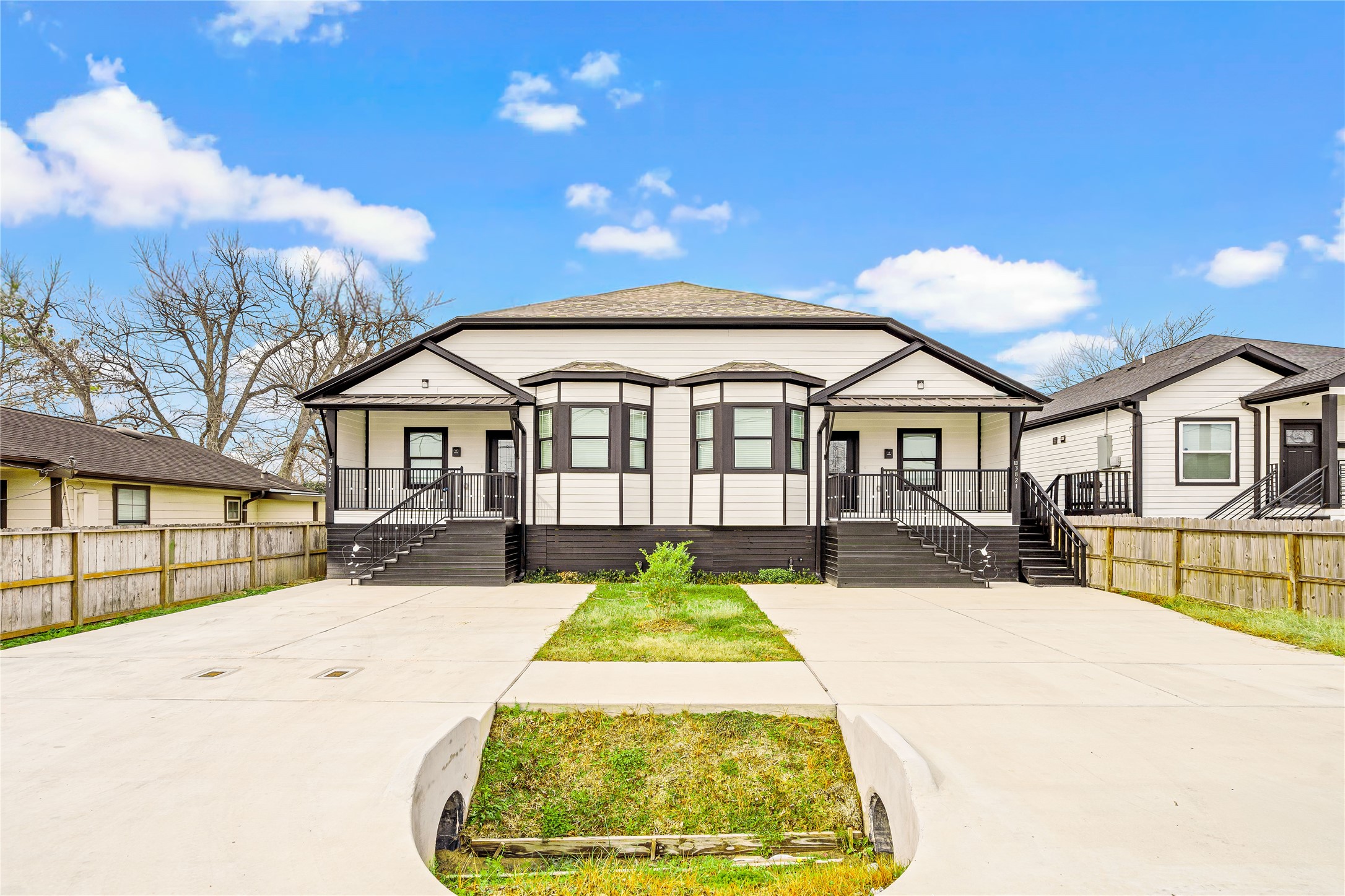 a view of a white house with a large pool and couches chairs