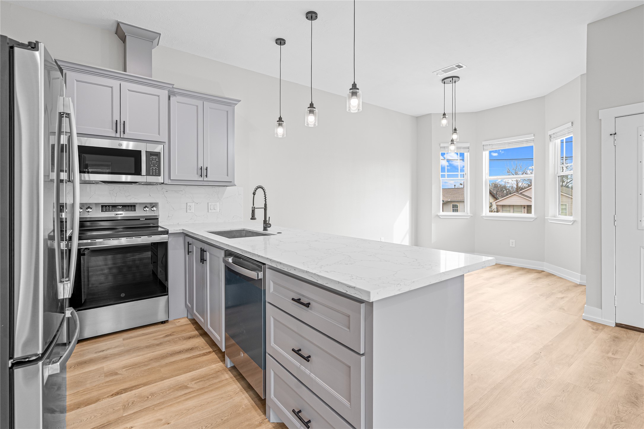 3821 Easy Street, Unit A Houston, TX 77026 - Photo 5 of 10 a kitchen with stainless steel appliances a stove sink microwave and refrigerator