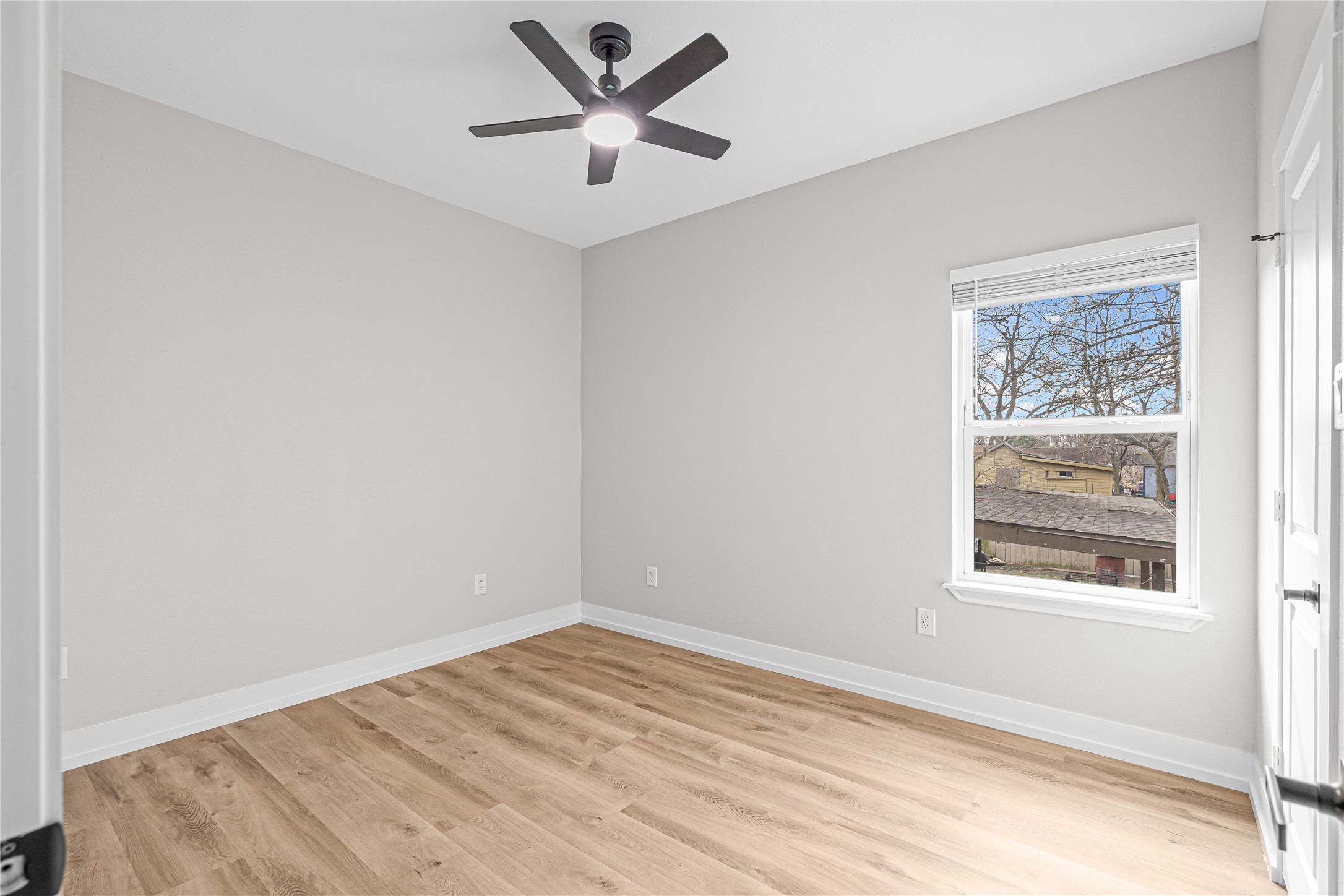 3821 Easy Street, Unit A Houston, TX 77026 - Photo 8 of 10 an empty room with a window and a ceiling fan