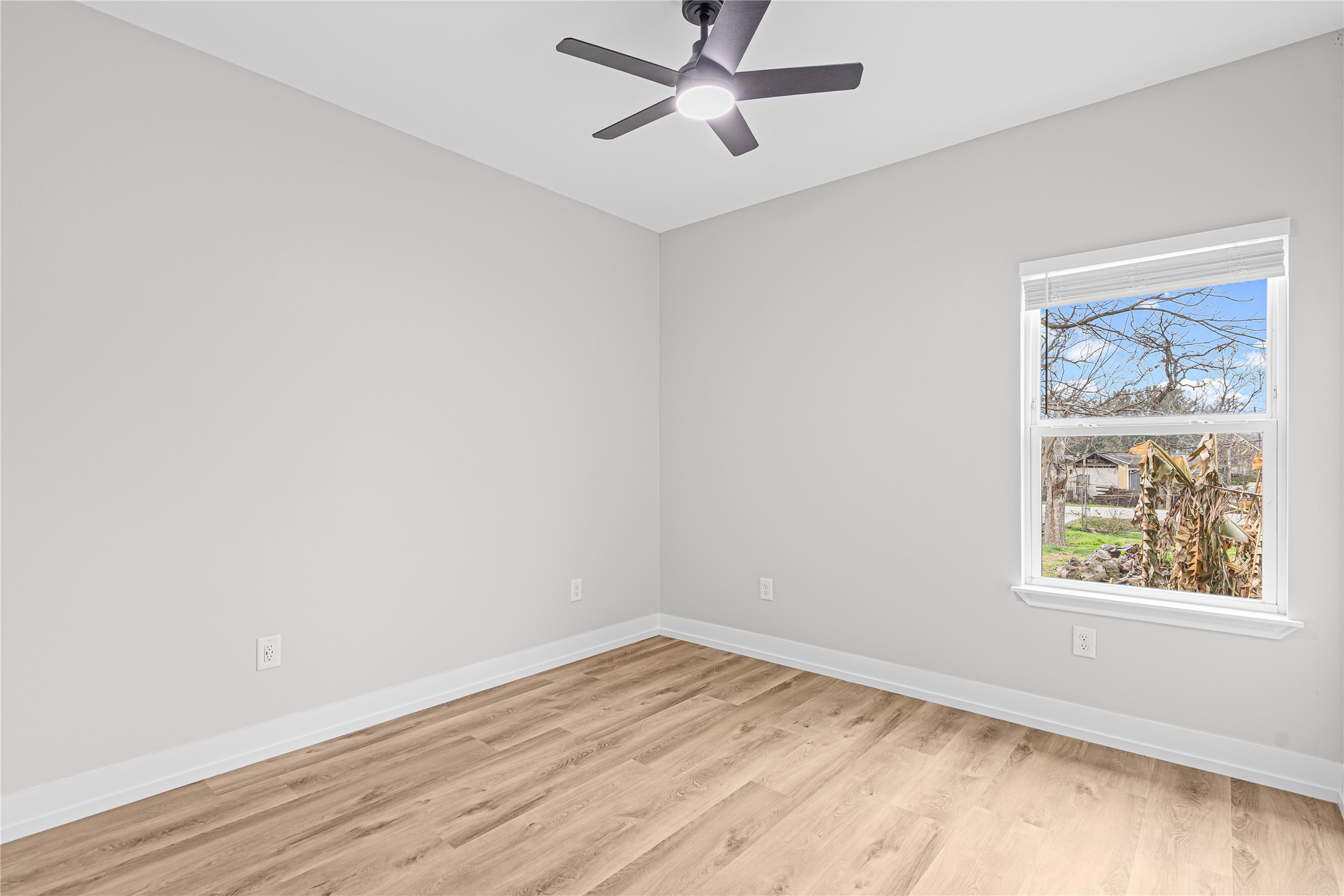 3821 Easy Street, Unit A Houston, TX 77026 - Photo 9 of 10 an empty room with a window and wooden floor