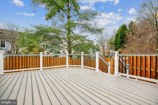 a view of a balcony with wooden floor and fence
