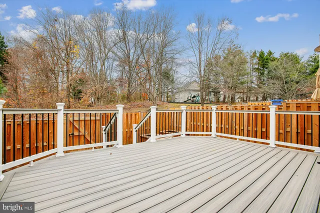 a view of a balcony with wooden floor and fence