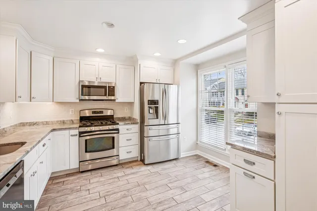a kitchen with stainless steel appliances a stove sink and microwave