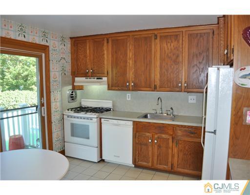 9 Agate Road East Brunswick, NJ 08816 - Photo 6 of 19 a kitchen with stainless steel appliances granite countertop a stove a sink dishwasher and a refrigerator