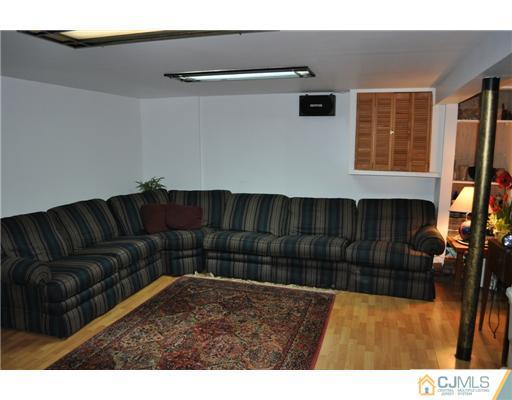 9 Agate Road East Brunswick, NJ 08816 - Photo 8 of 19 a living room with a couch and a bookshelf