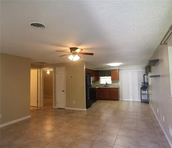 a large bathroom with a large tub shower vanity and a ceiling fan
