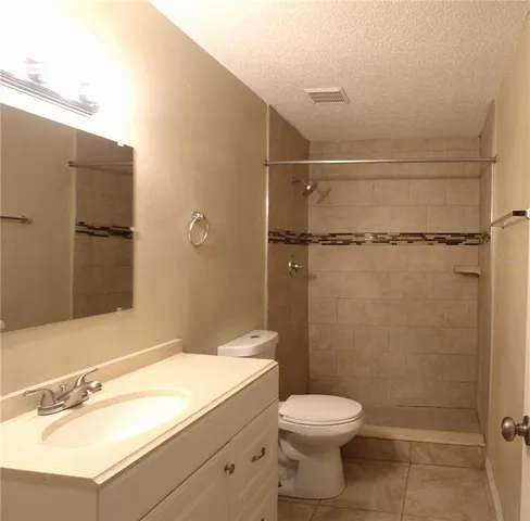 a bathroom with a sink mirror toilet and shower