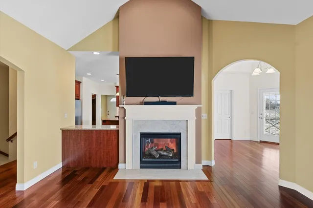 a kitchen with stainless steel appliances granite countertop a sink a stove and a refrigerator