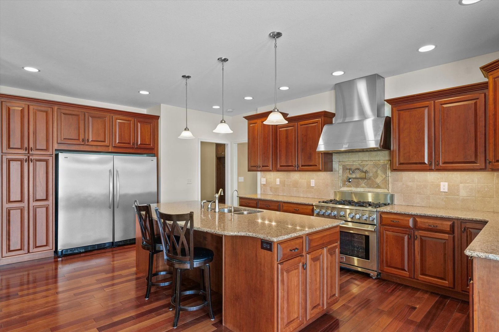 2595 500 East Mahomet, IL 61853 - Photo 13 of 84 a kitchen with stainless steel appliances granite countertop a sink a stove and a refrigerator