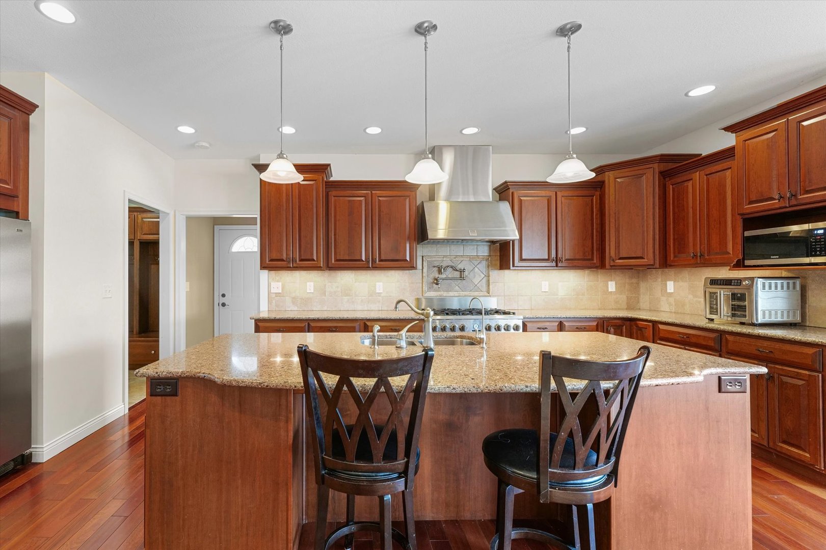 2595 500 East Mahomet, IL 61853 - Photo 17 of 84 a kitchen with stainless steel appliances granite countertop a stove a refrigerator a kitchen island a sink and a refrigerator