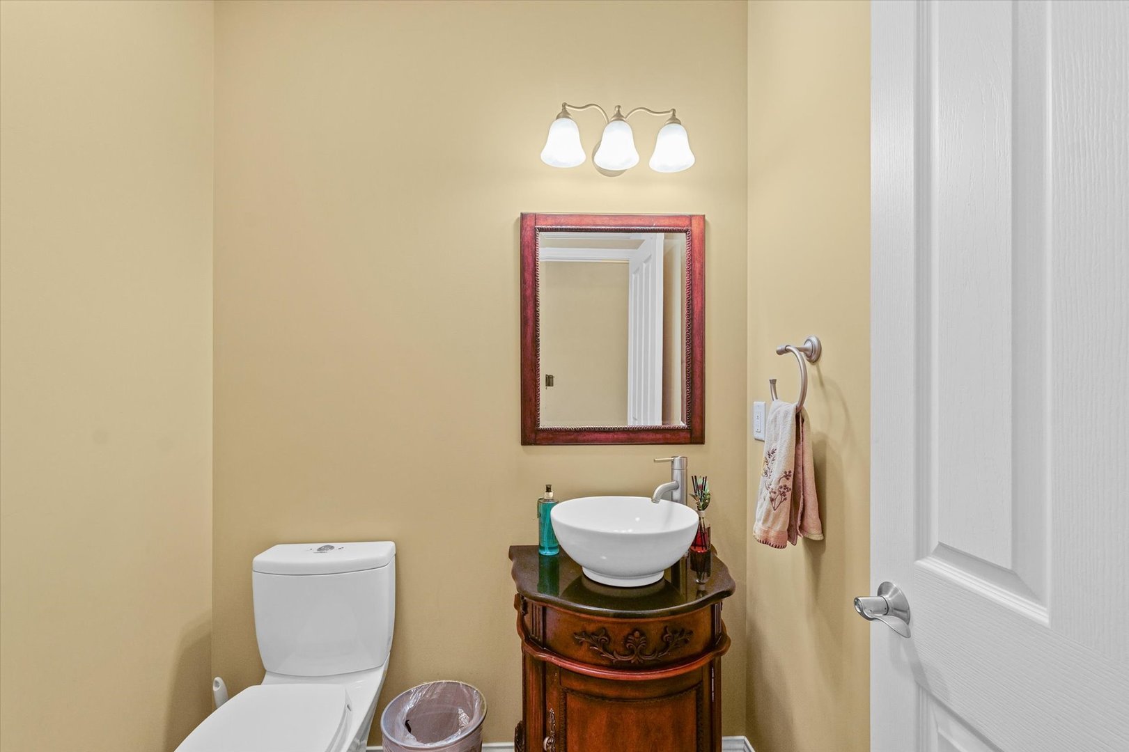 2595 500 East Mahomet, IL 61853 - Photo 30 of 84 a bathroom with a toilet a sink and mirror