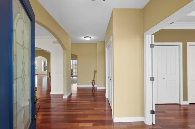 a view of a hallway with wooden floor