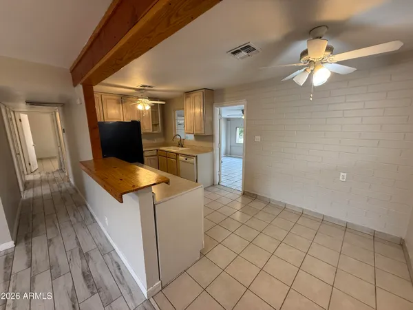 a kitchen with granite countertop a sink cabinets and wooden floor