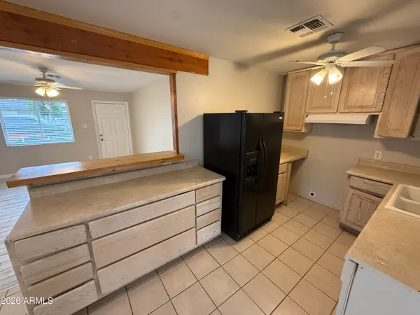 a kitchen with a refrigerator and cabinets