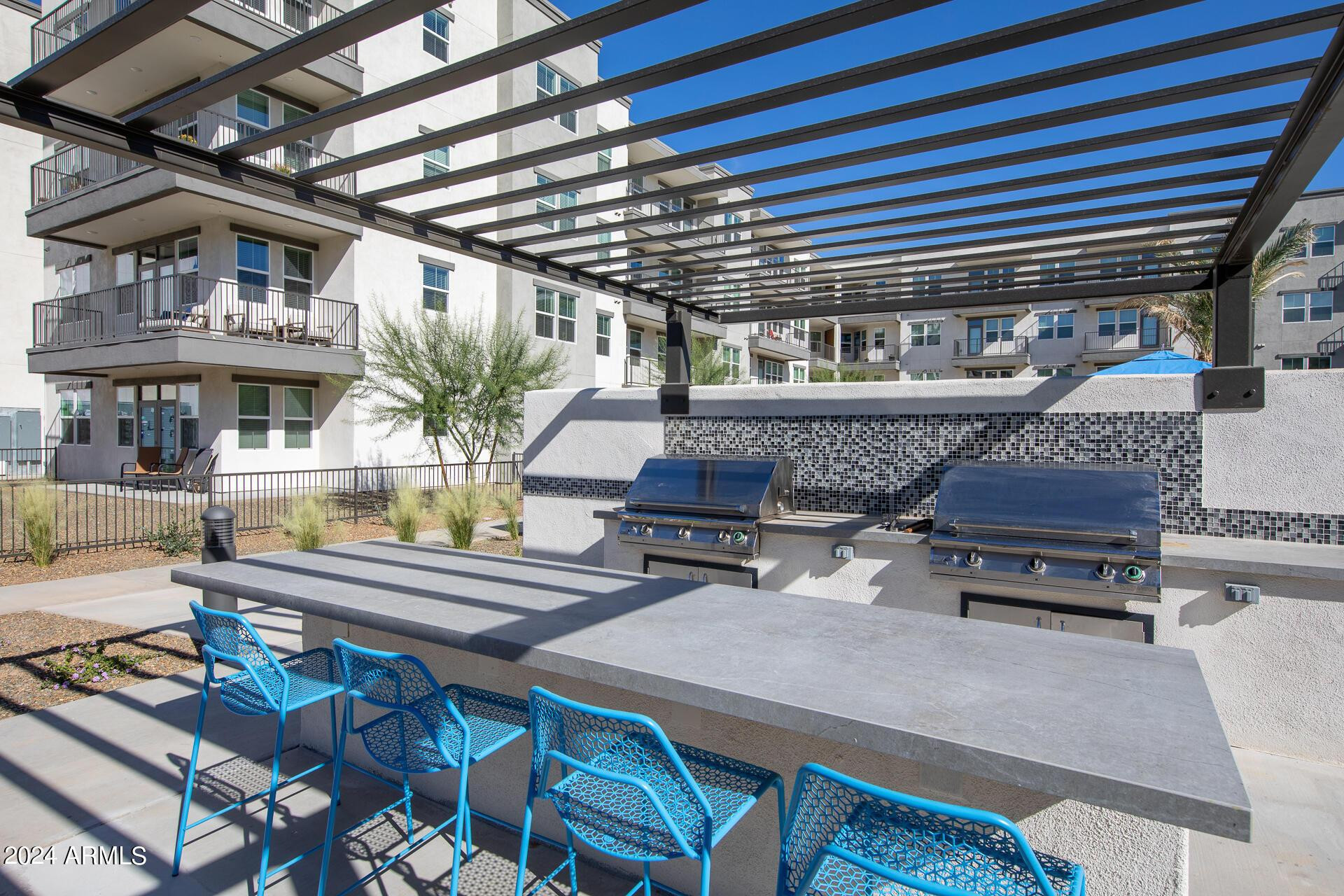 270 West Ocotillo Road, Unit A1 Queen Creek, AZ 85140 - Photo 4 of 12 a roof deck with a dining table and chairs with wooden floor