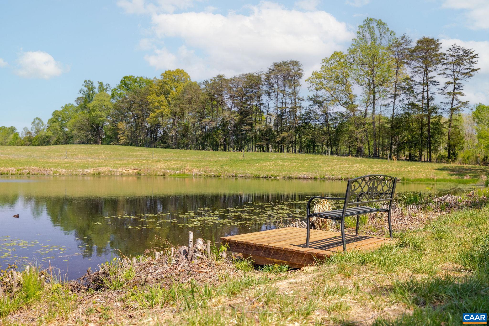 Tbd Cedar Plains Road Sandy Hook, VA 23153 - Photo 24 of 55 a view of a lake with a yard and trees