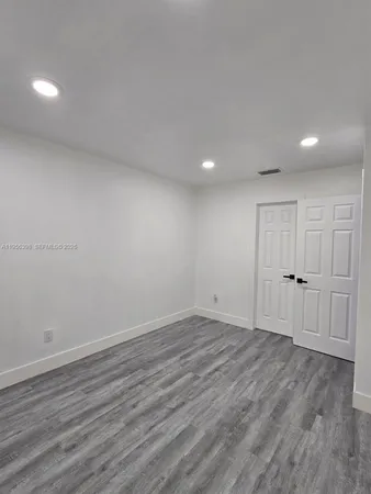 a bathroom with a tub shower sink and mirror