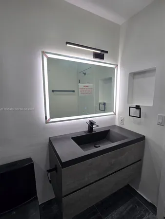 a bathroom with a shower and a sink