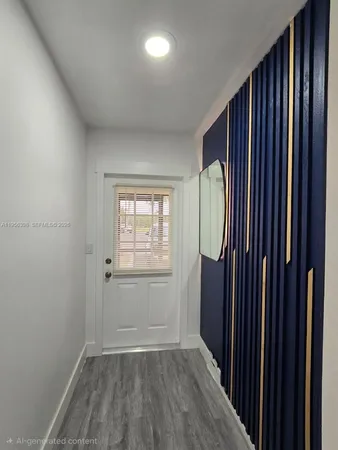 an empty room with wooden floor and a window