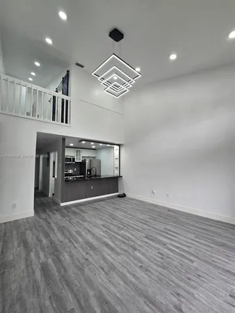 a view of an empty room with stairs and ventilation