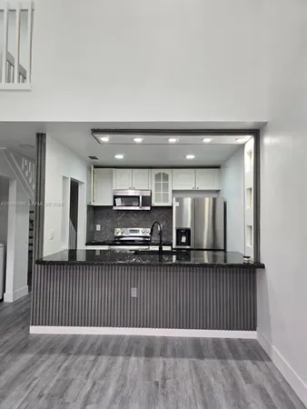 a view of kitchen with wooden floor