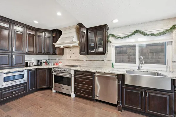 a kitchen with stainless steel appliances granite countertop a stove and a sink