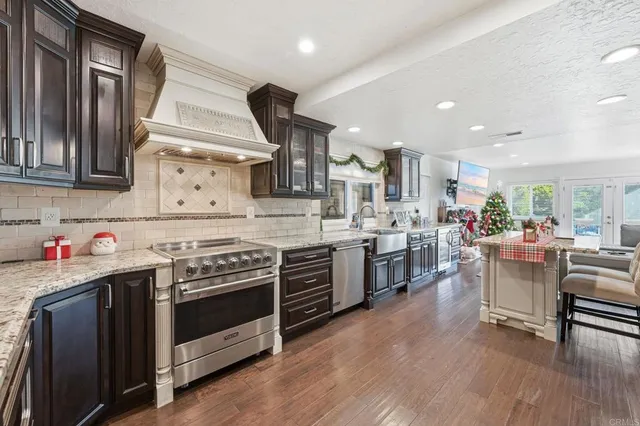 a kitchen with a stove and white cabinets