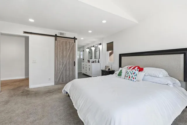 a bedroom with a large bed and a cabinets