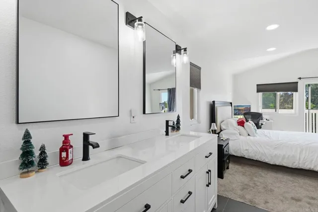 a bathroom with a double vanity sink and a mirror